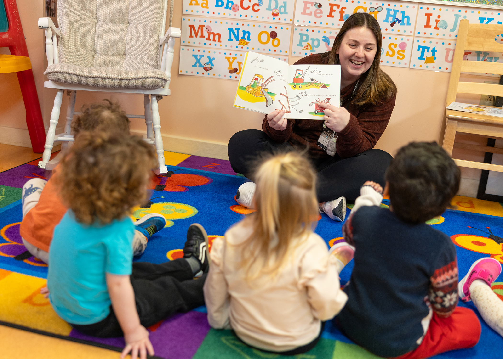 A teacher reading to children in a JCC Buffalo early childhood classroom