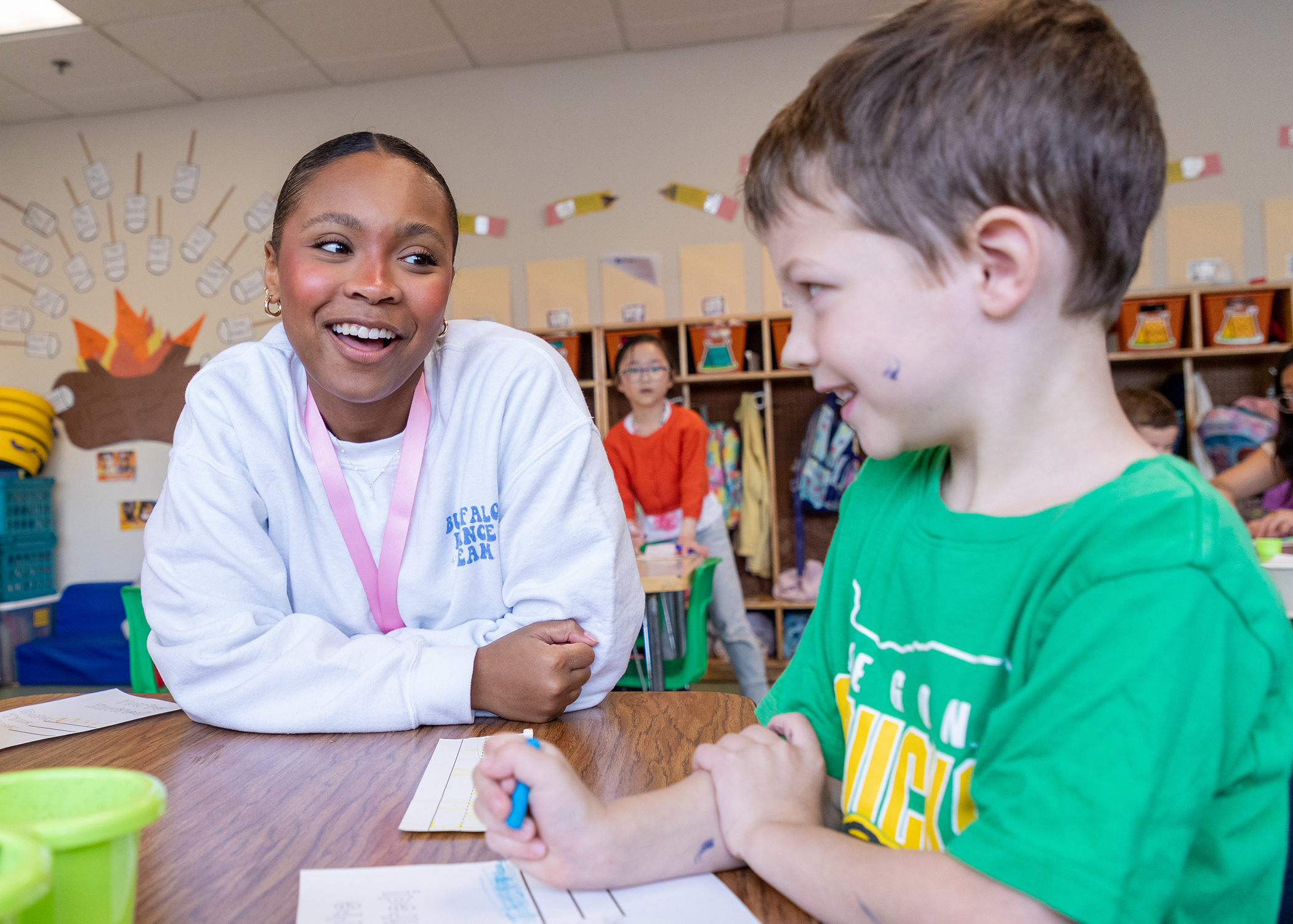 A teacher guiding children through a classroom learning activity at JCC Buffalo